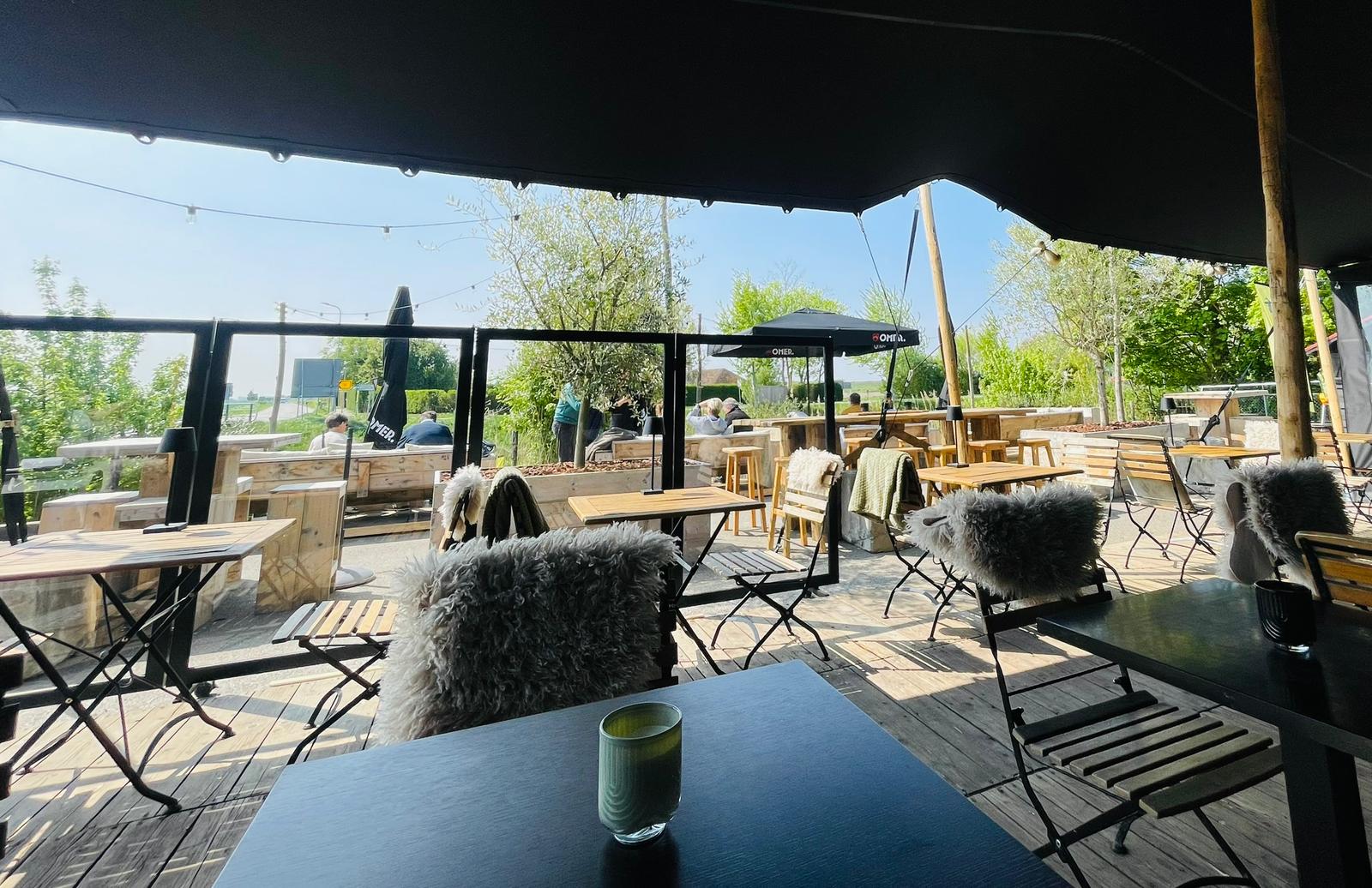 Terras van La Terrasse 364 onder de stretchtent met uitzicht op de Zeeuwse polder